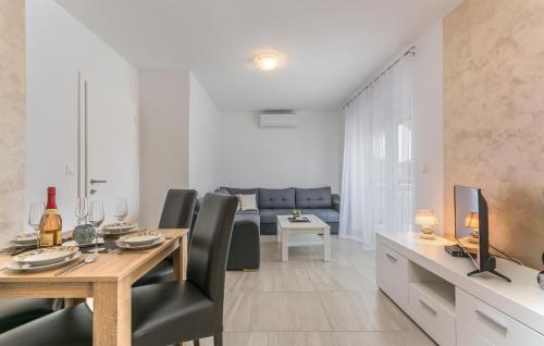 a dining room and living room with a table and chairs at Villa Stephany in Poreč