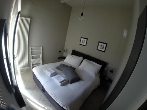 a bedroom with a bed with white sheets and pillows at Doma 4.2 in Riccione