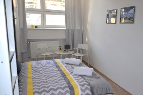 a bedroom with a bed and a table with chairs at Hostel Bratislava in Bratislava