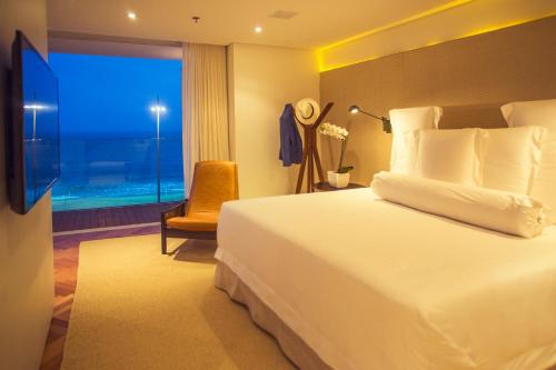 a hotel room with a bed and a window at Emiliano Rio in Rio de Janeiro