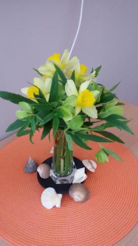 a vase of flowers on top of a table at Apartmani RALE rooms in Sarajevo
