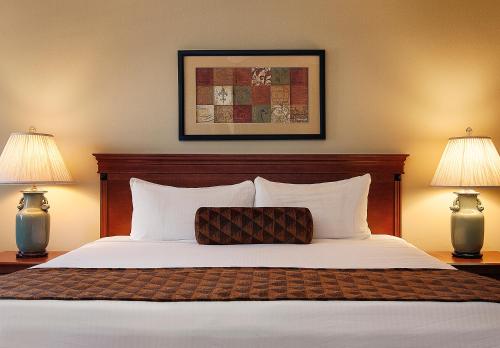 a bedroom with a large bed with two lamps at Brisas Del Mar Inn at the Beach in Santa Barbara
