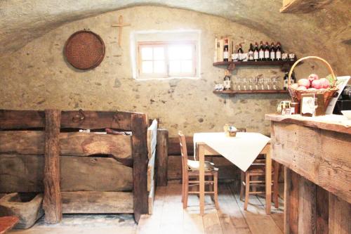 a dining room with a table and a table and chairs at Contrada Beltramelli in Villa di Tirano