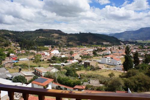 a view of a town with mountains in the background at San Benito Hotel in Tibasosa
