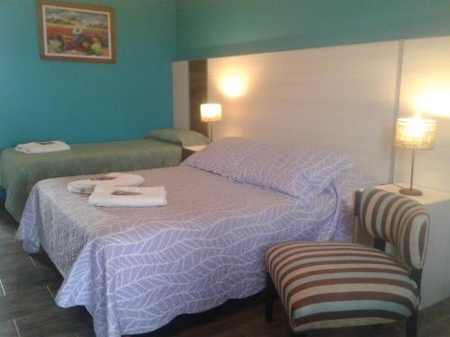 a hotel room with two beds with towels on them at Altos de Adonai in Pueblo Quintana