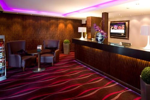 a hotel room with a large screen tv on the wall at Manchester South Hotel, Sure Hotel Collection by BW in Manchester