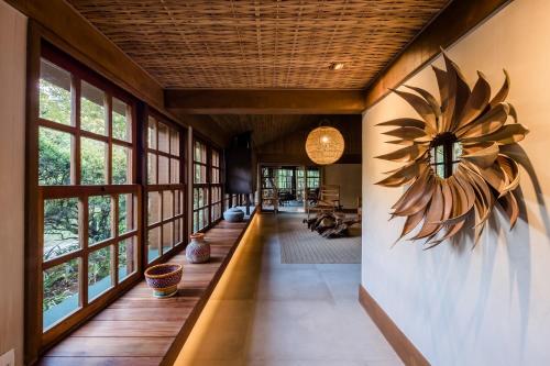 a hallway of a house with a sunflower on the wall at Pousada Tankamana in Itaipava