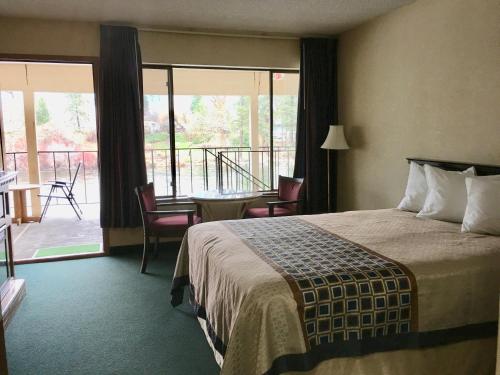 a hotel room with a bed and a balcony at River's Edge Lodge in Leavenworth