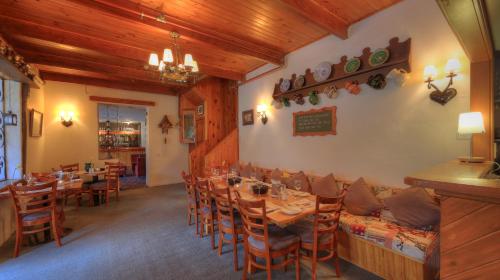 a dining room with a long table and chairs at Candlelight Lodge in Thredbo