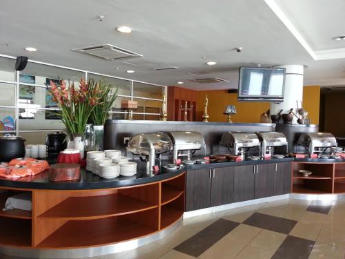 a kitchen with a counter with food on it at Hotel Seri Malaysia Kuala Terengganu in Kuala Terengganu