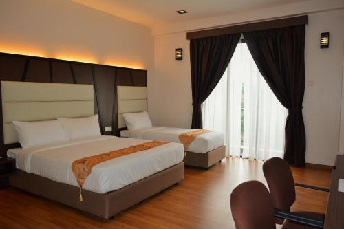 מיטה או מיטות בחדר ב-Hotel Grand Baron