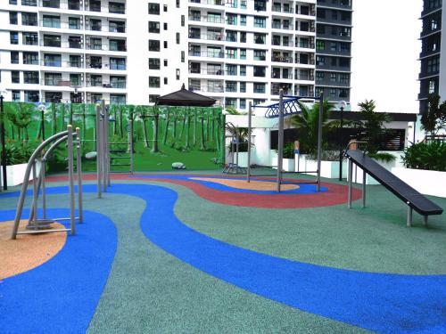 a playground with a slide and slides at Santorini by J&G Vacation Homes in Skudai