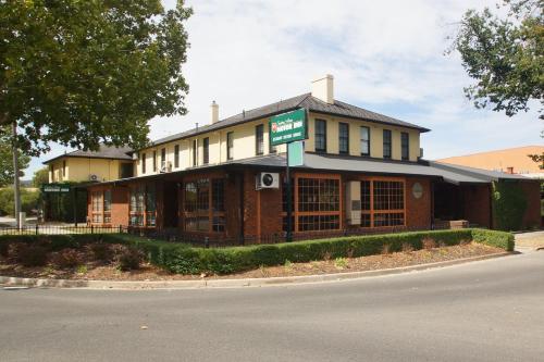 a building with a sign on the front of it at Seaton Arms Motor Inn in Albury
