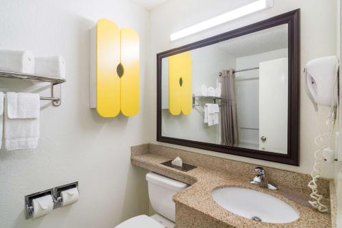 a bathroom with a sink and a mirror and a toilet at Studio 6-Plano, TX - Dallas - Plano Medical Center in Plano