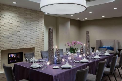 a conference room with a long table with chairs and a fireplace at Hyatt Regency Deerfield in Deerfield