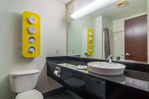 a bathroom with a sink and a toilet and a mirror at Motel 6-Dallas, TX - North - Richardson in Dallas