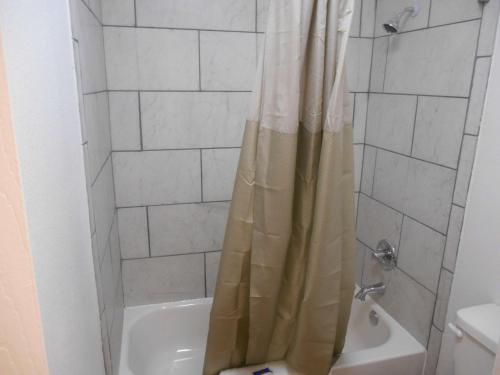 a shower with a shower curtain in a bathroom at Motel 6-Abilene, TX in Abilene