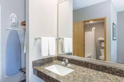 a bathroom with a sink and a mirror at Super 8 by Wyndham Carroll/East in Carroll