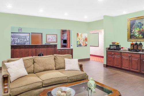 a living room with a couch and a table at Super 8 by Wyndham Central City in Central City