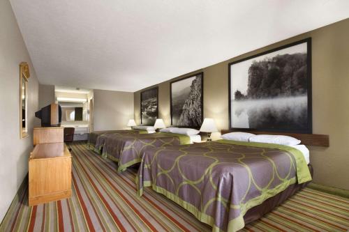 a hotel room with two beds and a television at Super 8 by Wyndham Fort Chiswell Wytheville Area in Max Meadows
