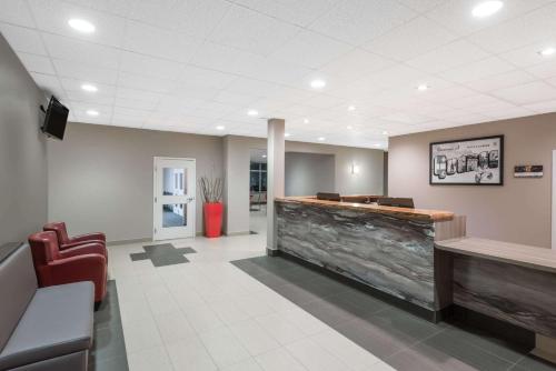 a lobby of a hospital with a reception desk and chairs at Super 8 by Wyndham Mont Laurier in Mont-Laurier