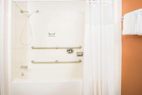 y baño con ducha con cortina blanca. en Super 8 by Wyndham Daleville/Roanoke, en Daleville