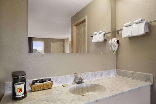 a bathroom with a sink and a large mirror at Super 8 by Wyndham Fort Chiswell Wytheville Area in Max Meadows