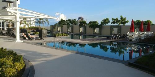 a swimming pool on the side of a building at Mactan Newtown Seaview at One Pacific Residence in Mactan