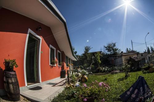 a house with an open door and some flowers at Giuggiolando in LʼAquila