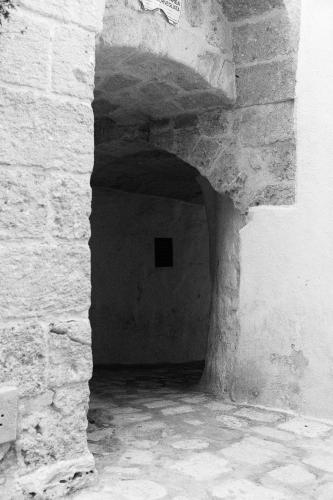a black and white photo of a stone hallway in a building at A sud Holiday House in Polignano a Mare