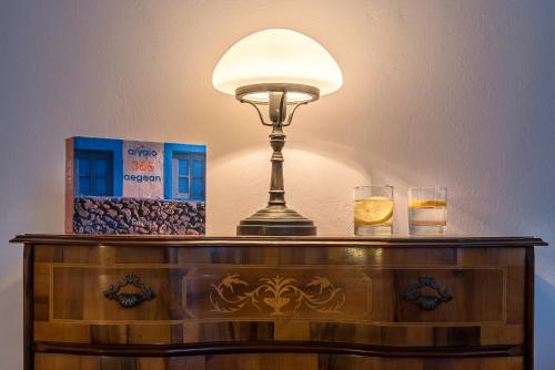 a dresser with a lamp on top of it at Hotel Amphora in Chania Town
