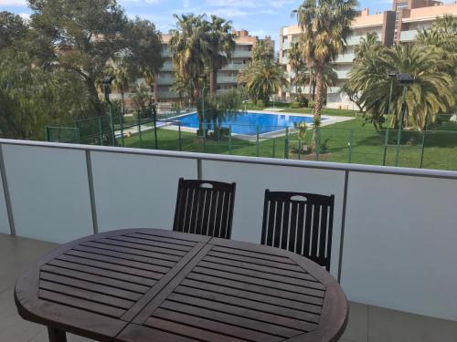 a balcony with a table and chairs and a swimming pool at Saval Spa Aqquaria Family Complex in Salou