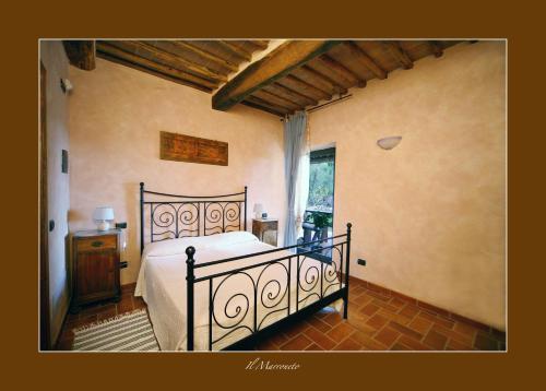 a bedroom with a large bed in a room at Podere Marroneto in Lama