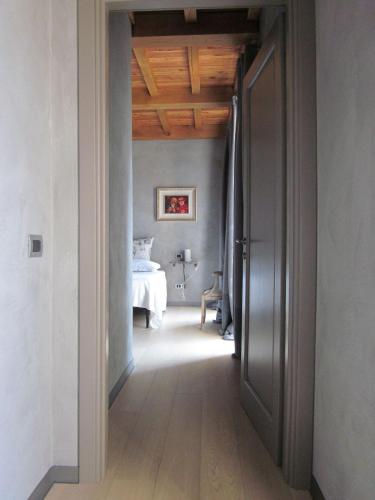a hallway leading to a bedroom with a bed at Agriresort Villa Gelso- Adults Friendly in Vesime