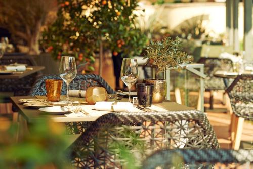 a table with wine glasses on it in a restaurant at Giardino Ascona in Ascona