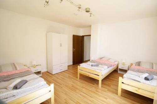 a bedroom with two twin beds and wooden floors at Apartment Merklingen in Merklingen