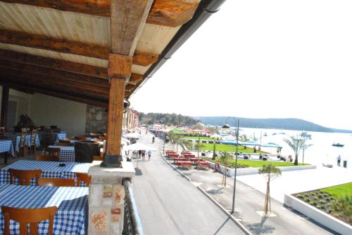 a restaurant with tables and chairs and a view of the water at Guesthouse Promenade in Medulin