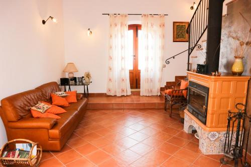 a living room with a couch and a fireplace at B&B Le Ginestre in Cefalù