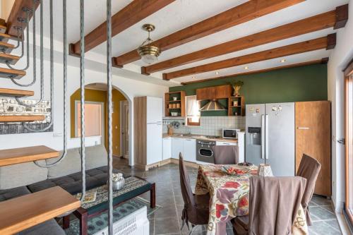 a kitchen with a table and a refrigerator at Apartments Villa San Antonio in Slatine