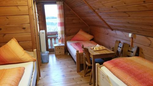 a room with two beds and a table in a cabin at Haus Lahneck bei Koblenz in Lahnstein
