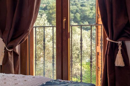 a bedroom with a window with a view of a garden at Apartments Villa San Antonio in Slatine