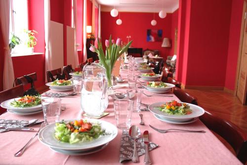 a long table with plates of food on it at Gutshaus Gottin in Warnkenhagen