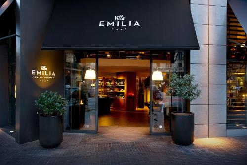 a store front with two potted plants in front of it at Hotel Villa Emilia in Barcelona