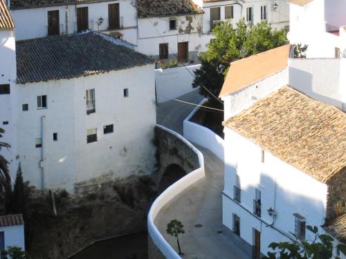 an aerial view of a city with white buildings at El Palacete in Setenil