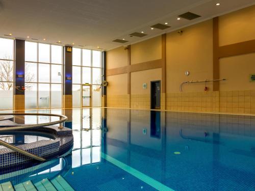 a large swimming pool in a building at Lady Gregory Hotel, Leisure Club & Beauty Rooms in Gort