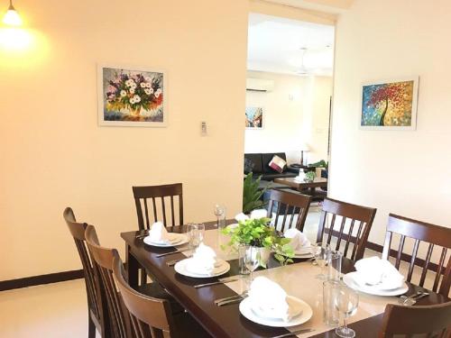 a dining room table with chairs and a tableablish at Vietnam Golf - Lake View Villas in Ho Chi Minh City