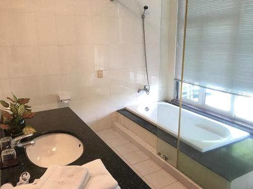 a bathroom with a sink and a bath tub at Vietnam Golf - Lake View Villas in Ho Chi Minh City