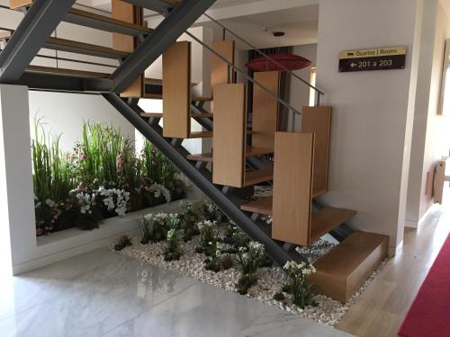 a staircase in a room with plants at Hotel Rural Quinta das Quintães in Penafiel