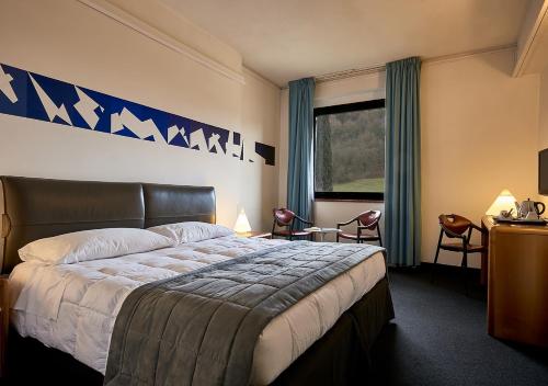 a hotel room with a bed and a window at Albornoz Palace Hotel in Spoleto