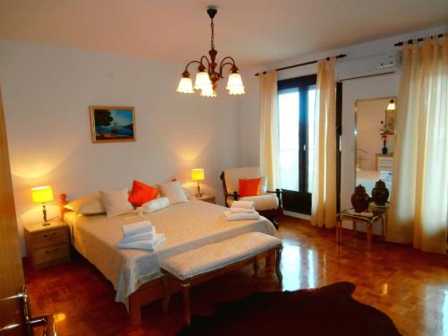 a bedroom with a large bed and a chandelier at Apartments Cordis in Split